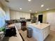Well-lit kitchen features an island, stainless steel appliances, and tile flooring at 32111 Brookstone Dr, Wesley Chapel, FL 33545