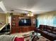 Inviting living room with a large media center, leather sofa, and cozy decor at 32111 Brookstone Dr, Wesley Chapel, FL 33545