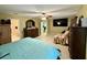 Large primary bedroom with ceiling fan, dresser, and view into office area at 32111 Brookstone Dr, Wesley Chapel, FL 33545