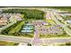 Stunning aerial view of community amenities featuring tennis courts, clubhouse, and parking in a beautifully landscaped setting at 32324 Rosewood Meadow Ln, Wesley Chapel, FL 33543