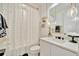 Modern bathroom featuring a vanity with white countertop, modern fixtures, and a shower with patterned curtains at 32324 Rosewood Meadow Ln, Wesley Chapel, FL 33543