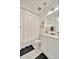 Bright bathroom features a modern vanity, decorative mirror, pendant lights, and a shower tub with patterned curtains at 32324 Rosewood Meadow Ln, Wesley Chapel, FL 33543
