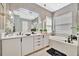 Elegant bathroom features double sinks, soaking tub, modern lighting, and stylish accents at 32324 Rosewood Meadow Ln, Wesley Chapel, FL 33543