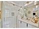 Modern bathroom featuring a glass-enclosed shower and white vanity with stylish lighting and decor at 32324 Rosewood Meadow Ln, Wesley Chapel, FL 33543