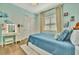 Cozy bedroom with blue decor features a vanity area and closet with bright natural light at 32324 Rosewood Meadow Ln, Wesley Chapel, FL 33543