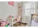 Bright bedroom area featuring a desk and chair next to a window with bright natural light at 32324 Rosewood Meadow Ln, Wesley Chapel, FL 33543