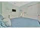 Bright bedroom with blue decor features a TV and vanity area with bright natural light at 32324 Rosewood Meadow Ln, Wesley Chapel, FL 33543