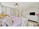 Comfortable bedroom featuring two twin beds, hardwood floors, and bright natural lighting at 32324 Rosewood Meadow Ln, Wesley Chapel, FL 33543
