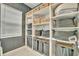 Custom closet system with shelving, baskets, and hanging storage at 32324 Rosewood Meadow Ln, Wesley Chapel, FL 33543
