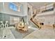 Bright dining room with chandelier, table and six chairs, tall windows, and open staircase at 32324 Rosewood Meadow Ln, Wesley Chapel, FL 33543