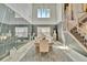 Sophisticated dining area with a wall mirror, table, six chairs, and modern decor at 32324 Rosewood Meadow Ln, Wesley Chapel, FL 33543