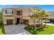 Beautiful two-story home boasts a stone facade, tile roof, lush landscaping and a three-car garage at 32324 Rosewood Meadow Ln, Wesley Chapel, FL 33543