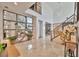 Bright and spacious foyer with high ceilings, staircase, contemporary decor, and marble flooring at 32324 Rosewood Meadow Ln, Wesley Chapel, FL 33543