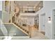 Bright foyer with wooden staircase, iron railings, and marble floors creating a welcoming entrance at 32324 Rosewood Meadow Ln, Wesley Chapel, FL 33543