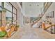 Grand two-story foyer with marble floors, staircase, modern lighting, and elegant decor at 32324 Rosewood Meadow Ln, Wesley Chapel, FL 33543