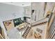 Open layout hallway overlooks the dining room with modern lighting at 32324 Rosewood Meadow Ln, Wesley Chapel, FL 33543