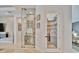Hallway featuring a glass-enclosed wine cellar and a pantry with glass door at 32324 Rosewood Meadow Ln, Wesley Chapel, FL 33543