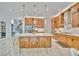 Modern kitchen featuring an island with seating, wood cabinetry, and stainless steel appliances at 32324 Rosewood Meadow Ln, Wesley Chapel, FL 33543