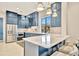 A modern kitchen with stainless steel appliances, marble countertops, and ample cabinet space at 32324 Rosewood Meadow Ln, Wesley Chapel, FL 33543
