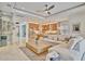 Spacious open-concept living room with modern furnishings, seamless flow to the kitchen, and lots of natural light at 32324 Rosewood Meadow Ln, Wesley Chapel, FL 33543