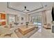 Open-concept living room with modern decor, a large sectional sofa, and sliding glass doors to the outdoor pool area at 32324 Rosewood Meadow Ln, Wesley Chapel, FL 33543