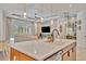 Open-concept living room featuring a kitchen island, modern decor, and a comfortable seating area at 32324 Rosewood Meadow Ln, Wesley Chapel, FL 33543
