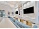 Modern clubhouse lounge area featuring stylish seating, TV screens, and decorative elements at 32324 Rosewood Meadow Ln, Wesley Chapel, FL 33543