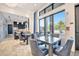 A comfortable community lounge area with tables and chairs overlooking a pool and outdoor space at 32324 Rosewood Meadow Ln, Wesley Chapel, FL 33543