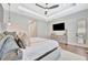 Spacious main bedroom features modern ceiling fan, hardwood floors, and stylish décor at 32324 Rosewood Meadow Ln, Wesley Chapel, FL 33543
