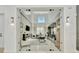 Office with a glass door showcasing a modern desk, neutral color palette, and bright natural light at 32324 Rosewood Meadow Ln, Wesley Chapel, FL 33543