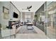 Modern office with a ceiling fan, a large desk, and a cozy seating area at 32324 Rosewood Meadow Ln, Wesley Chapel, FL 33543