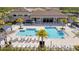 Resort-style swimming pool with lounge chairs, palm trees, and shaded seating areas, perfect for relaxation and leisure at 32324 Rosewood Meadow Ln, Wesley Chapel, FL 33543