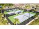Well-maintained tennis courts with covered seating areas and professional fencing for an exceptional playing experience at 32324 Rosewood Meadow Ln, Wesley Chapel, FL 33543
