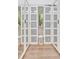 Bright walk-in closet with custom storage solutions and mirrored doors at 32324 Rosewood Meadow Ln, Wesley Chapel, FL 33543