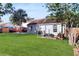 Spacious backyard with lush green grass, a cozy fire pit, and mature trees at 3238 6Th W Ave, Palmetto, FL 34221