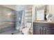 Bathroom featuring gray tiled walk-in shower and storage shelves at 3238 6Th W Ave, Palmetto, FL 34221