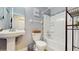 Bathroom with pedestal sink, tile floor, shower-tub, and decorative accents at 3238 6Th W Ave, Palmetto, FL 34221