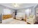 Bedroom with white crib, accent wall, woven baskets, and a comfortable armchair at 3238 6Th W Ave, Palmetto, FL 34221