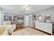 Bedroom featuring wood floors, open closet with clothing, and a white dresser at 3238 6Th W Ave, Palmetto, FL 34221