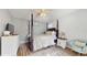 Bedroom featuring wood floors, a four-poster bed, ceiling fan, and decorative accents at 3238 6Th W Ave, Palmetto, FL 34221