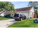 View of the home's exterior showing the garage, well-maintained lawn, and a dark colored SUV at 3238 6Th W Ave, Palmetto, FL 34221