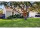 A mature oak tree creates shade in the front yard of this home with manicured landscaping at 3238 6Th W Ave, Palmetto, FL 34221