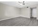 Bedroom with gray wood-look vinyl flooring, ceiling fan, and doorway at 3706 Greenery Ct # 206, Tampa, FL 33618