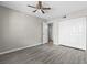 Large bedroom with stylish gray flooring and closet doors, complemented by a ceiling fan at 3706 Greenery Ct # 206, Tampa, FL 33618