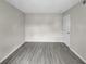 Bedroom with gray wood-look vinyl flooring and doorway to hallway at 3706 Greenery Ct # 206, Tampa, FL 33618