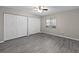 Bright bedroom features gray wood-look flooring, ceiling fan and spacious closets at 3706 Greenery Ct # 206, Tampa, FL 33618