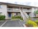 A multi-story condo building with exterior stairs and well-maintained landscaping at 3706 Greenery Ct # 206, Tampa, FL 33618