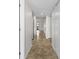 This is a brightly lit hallway with tiled floor that is leading to the entrance at 3706 Greenery Ct # 206, Tampa, FL 33618