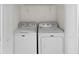 This laundry room features a side-by-side washer and dryer and a storage shelf above for convenience at 3706 Greenery Ct # 206, Tampa, FL 33618