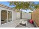 A backyard featuring a patio with outdoor seating, a privacy fence, and mature tree at 4003 W Lemon St, Tampa, FL 33609